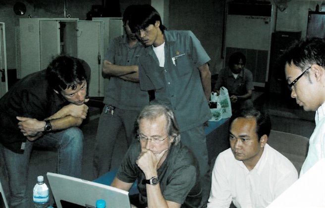 Schneider Lift engineering team collaborating around a computer