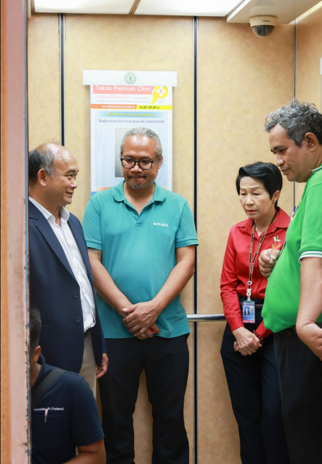 Hospital representatives inspect the renovated elevator interior
